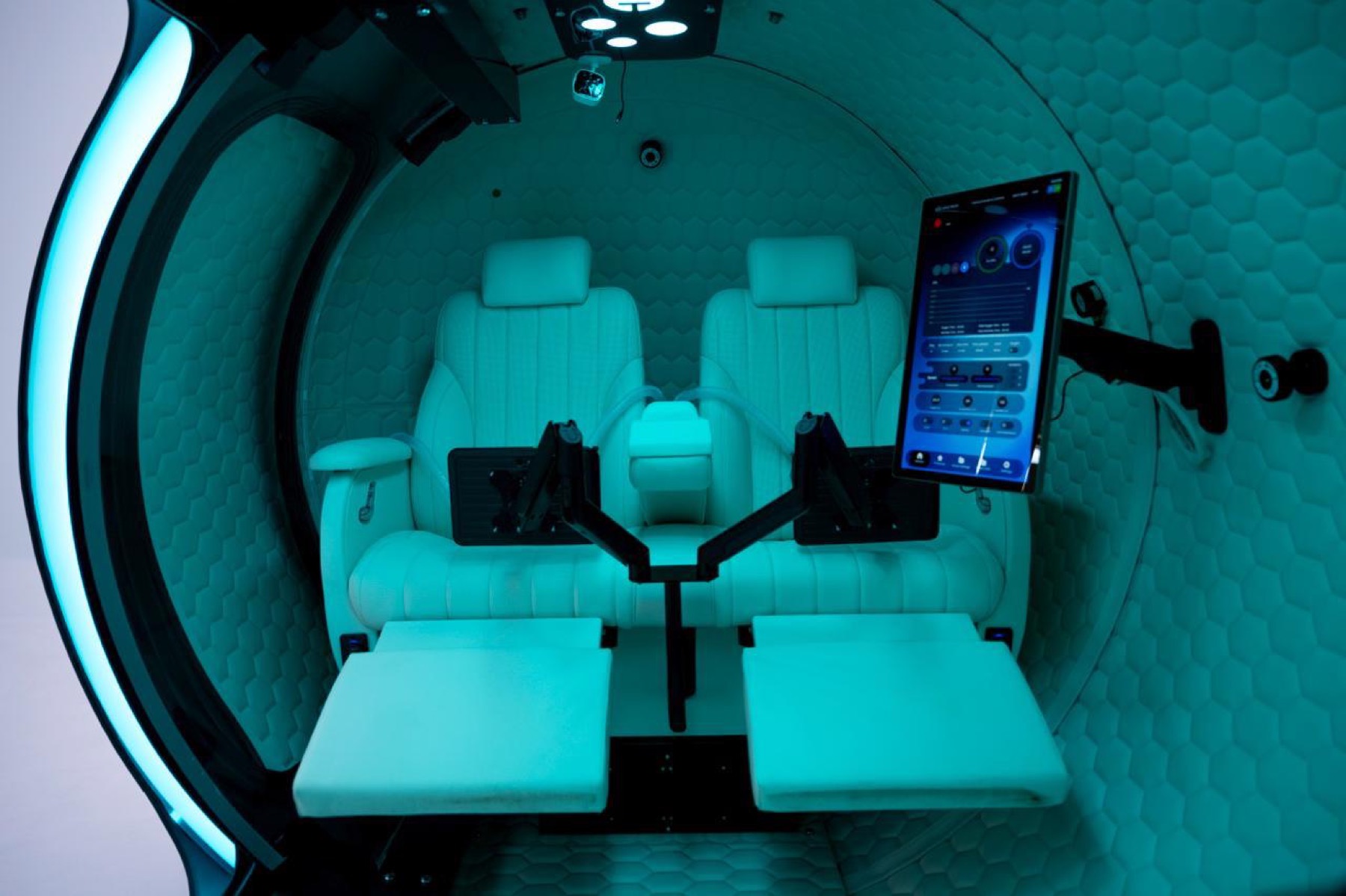 Inside The Four: reclining seats, screens, and controls